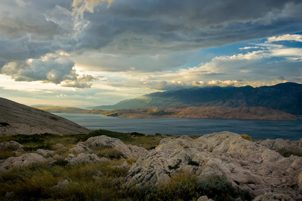 Rocky ground on Pag looking across the gulf to the Velebit mountains, Zadar