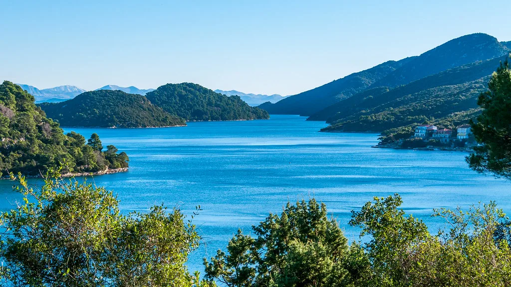 A wooded bay and blue water at Polače on the island of Mljet, Croatia