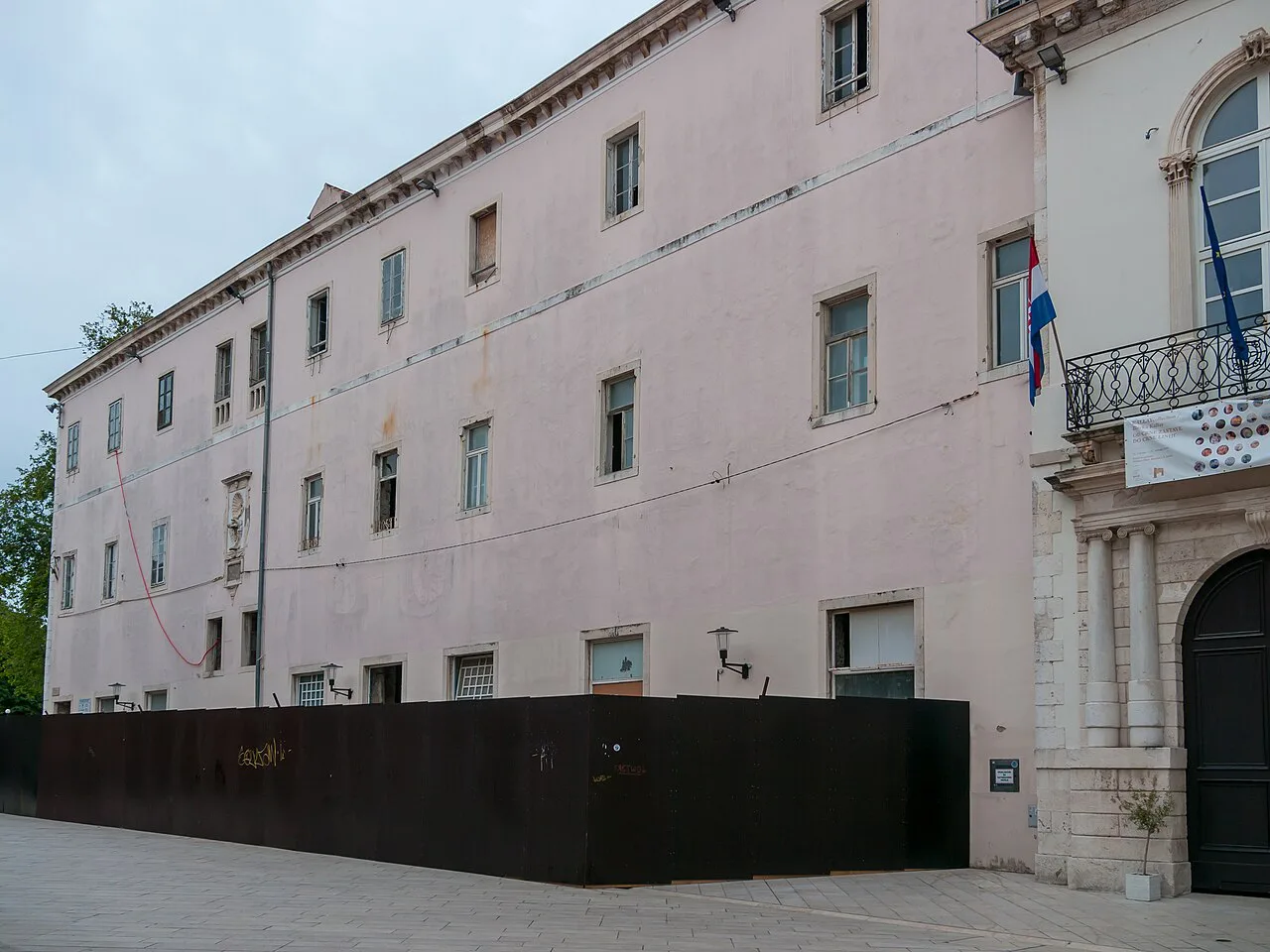 A pale stone building on a street in the Old Town of Zadar.
