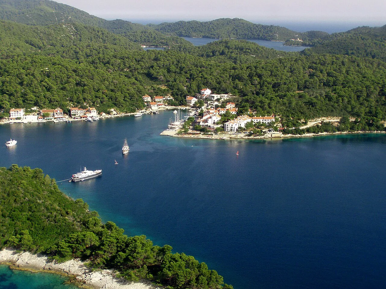The bay and small waterfront settlement of Pomena surrounded by wooded hills on Mljet, Croatia