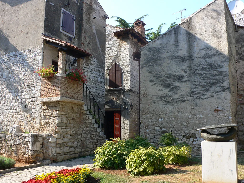 Stone houses and a small garden in the old town of Poreč