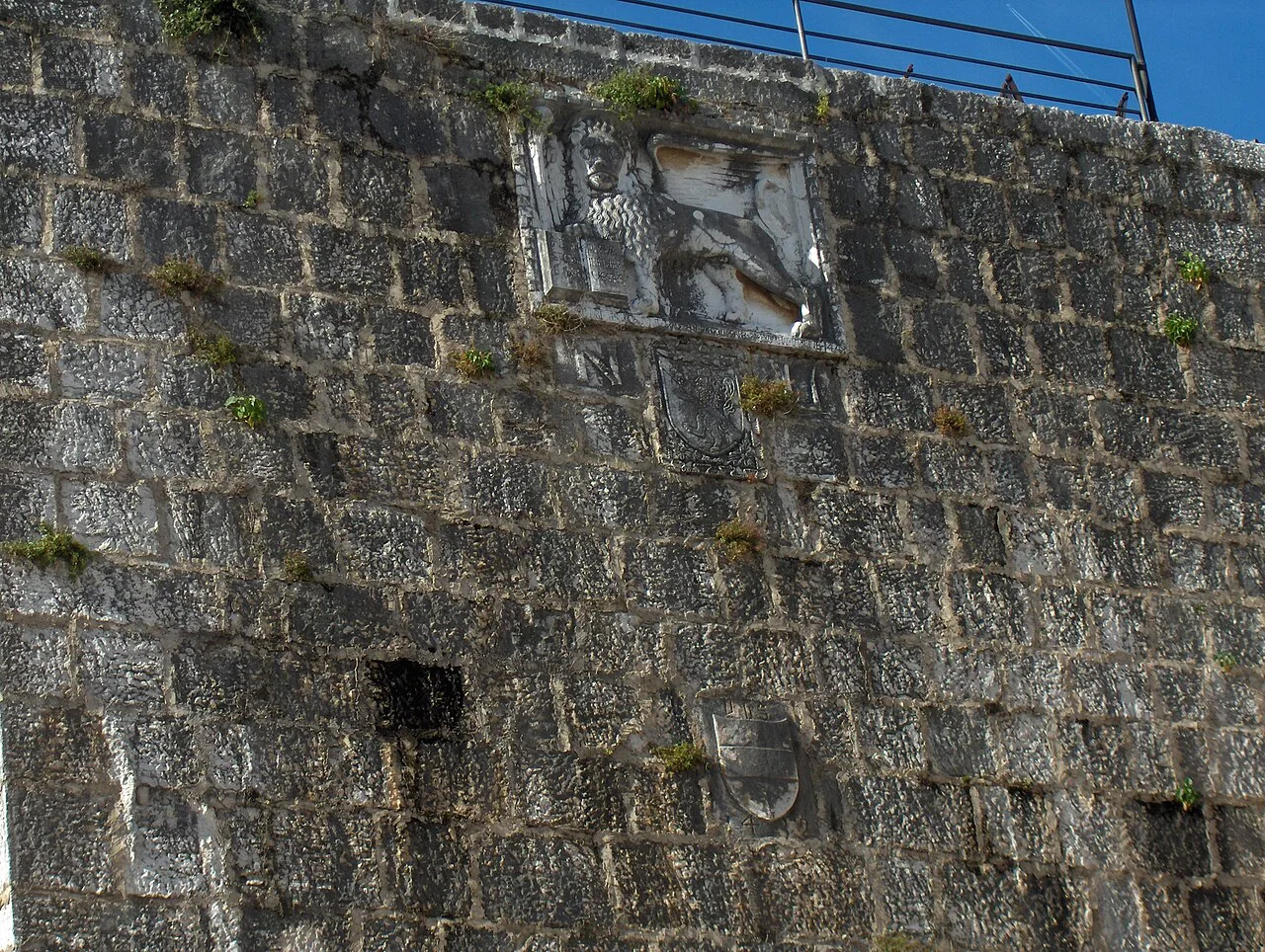 A Venetian lion relief on the stone wall of the Pentagonal Tower in Poreč