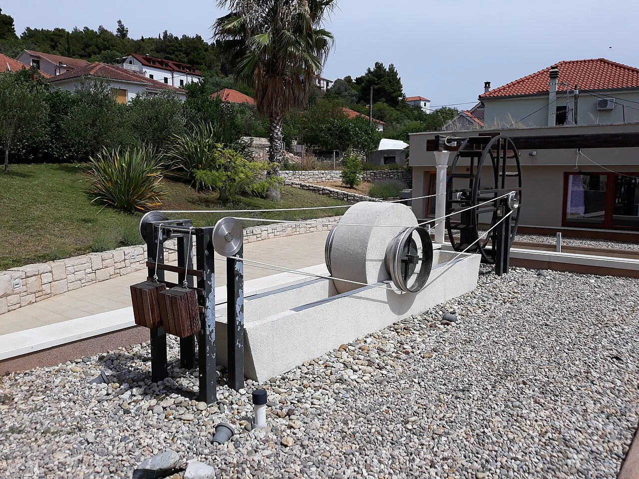 A historic mechanical model displayed outside a building on the island of Prvić, Šibenik