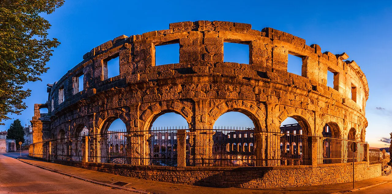 The outer arches of the Roman amphitheatre in Pula lit by low sun