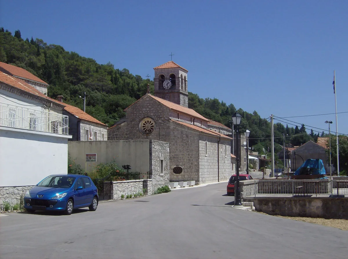 A stone church and houses beside the road in Pupnat on Korčula.