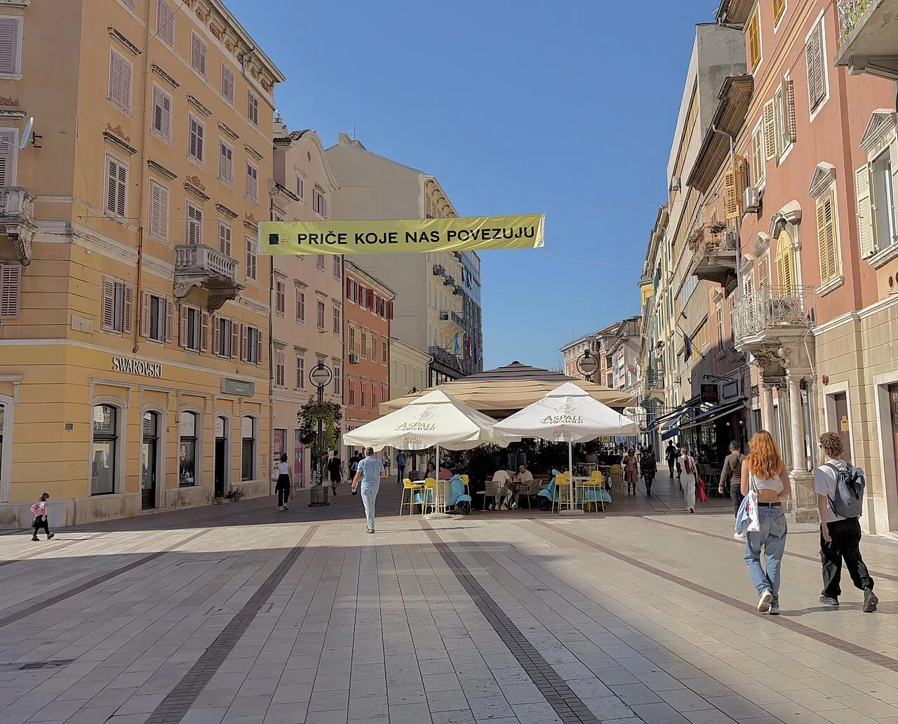 A pedestrian street lined with historic buildings in central Rijeka