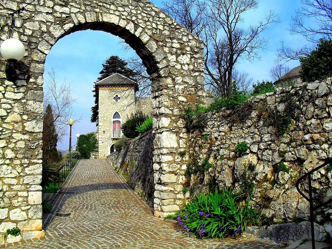 A stone archway leading to a path at Trsat Castle in Rijeka