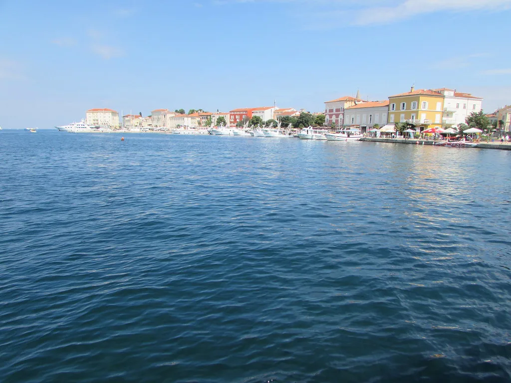 The waterfront of Poreč seen across the sea on a clear day