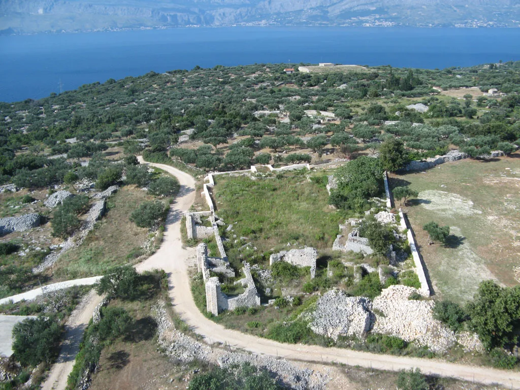 Aerial view of the Mirje archaeological site among olive groves near the sea, Croatia