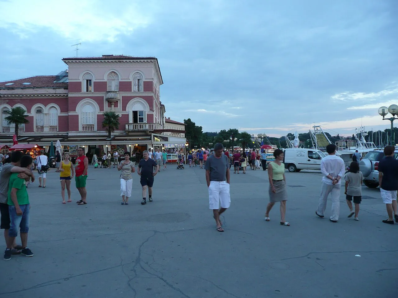 People walking across Narodni trg square in the centre of Poreč