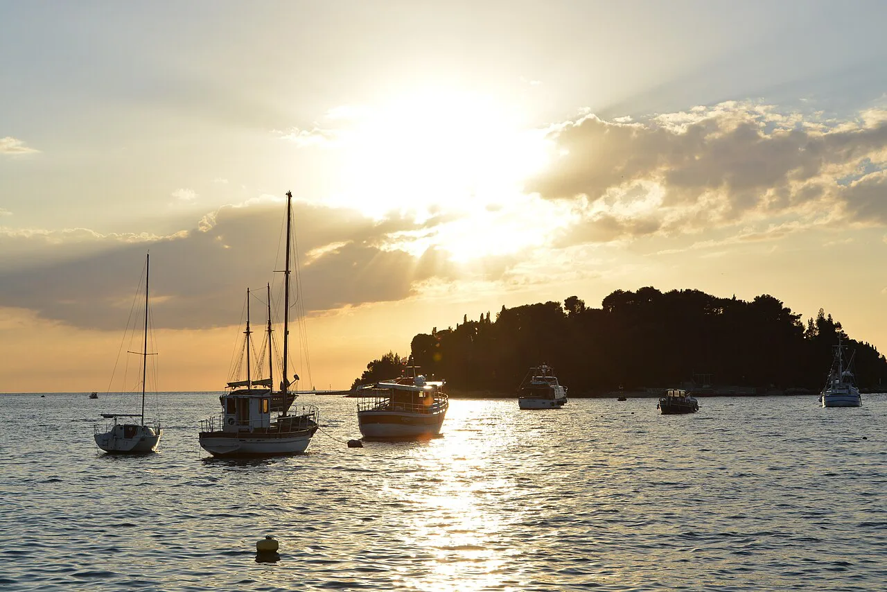Sailing boats at anchor off Rovinj at sunset