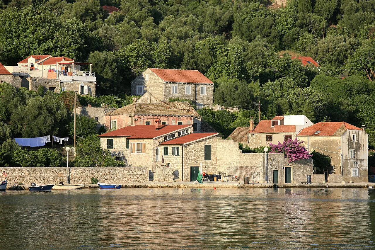 Stone houses with red roofs along the waterfront on the island of Šipan, Southern Dalmatia