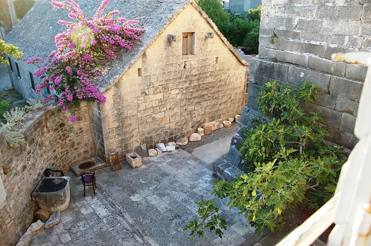 The courtyard of the Brač island museum in Škrip with flowering bougainvillea