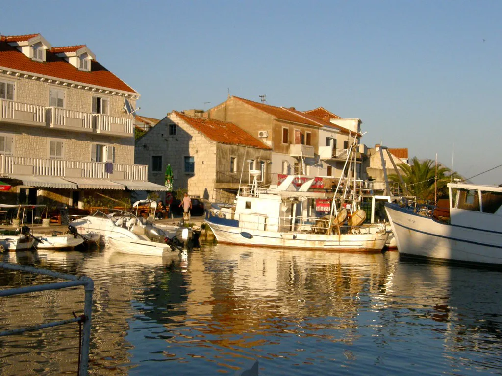 Stone houses and moored boats in the small harbour at Sućuraj on Hvar
