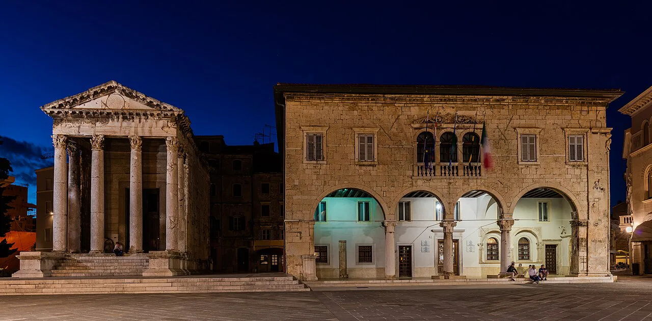 The Temple of Augustus beside the town hall on the forum in Pula at dusk.