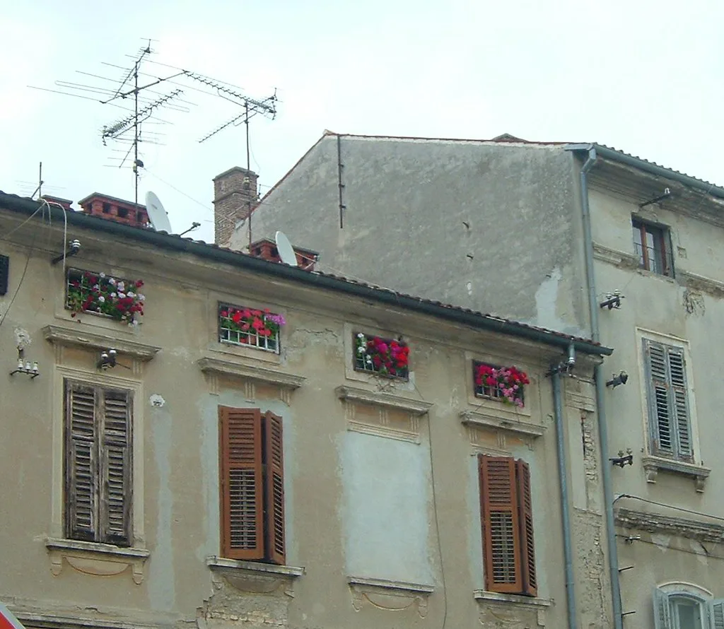 Old stone houses with wooden shutters in Pula.
