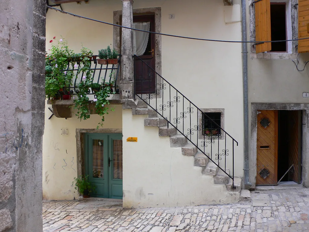 Stone houses with an outdoor staircase in the old town of Rovinj.
