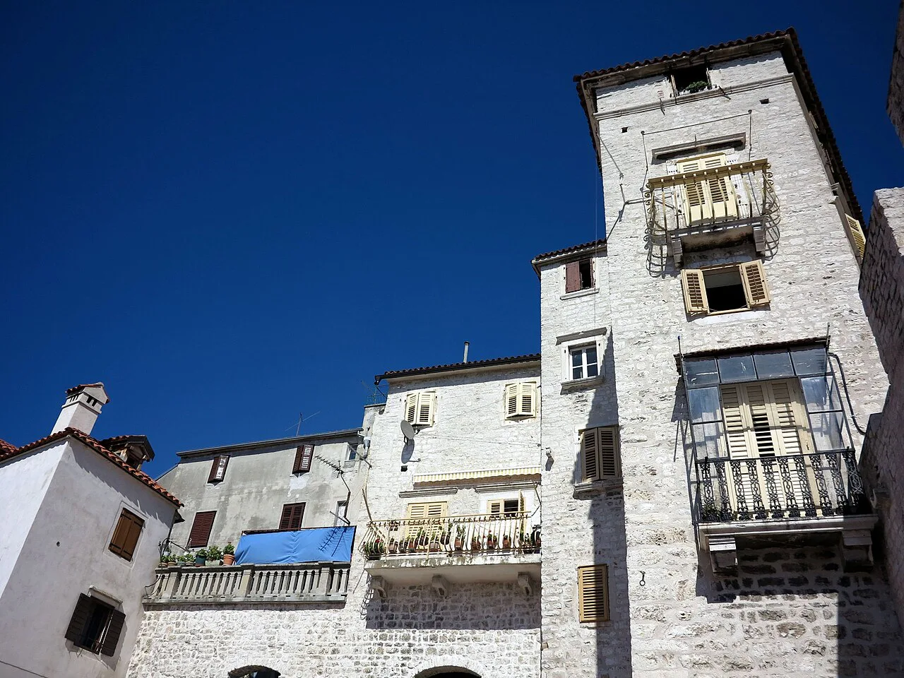 Tall stone houses in the old town of Šibenik near the cathedral.
