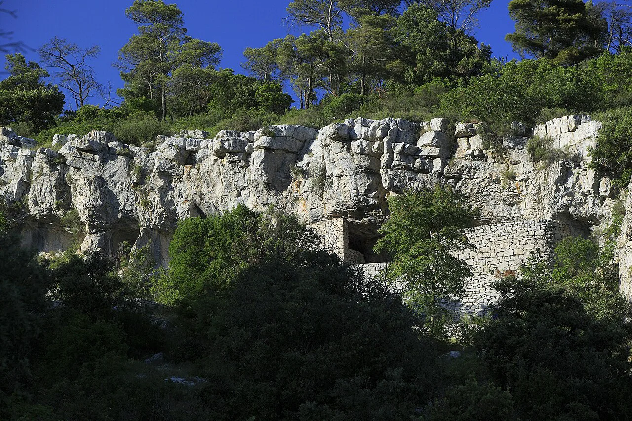 Cave openings in a limestone cliff at Tito's Cave on the island of Vis