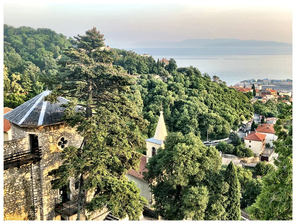 Trsat's church and castle tower among trees on the hill above Rijeka