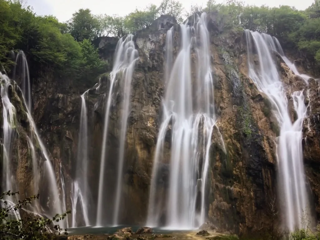 Waterfalls cascading down limestone cliffs in Plitvice Lakes National Park, Croatia