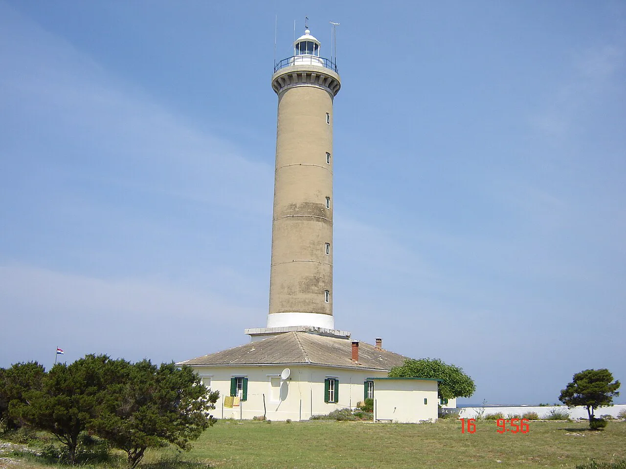 The tall Veli Rat lighthouse tower and keeper's house on Dugi otok.