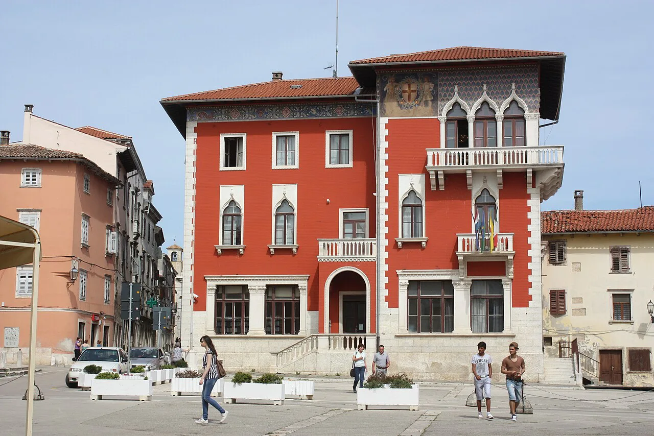 A red palace with Gothic-style windows on Narodni trg in Vodnjan, Istria