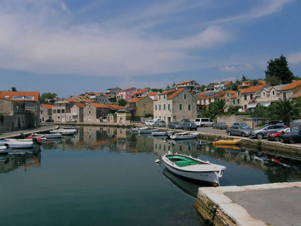 Houses and moored boats along the harbour inlet in Vrboska on Hvar
