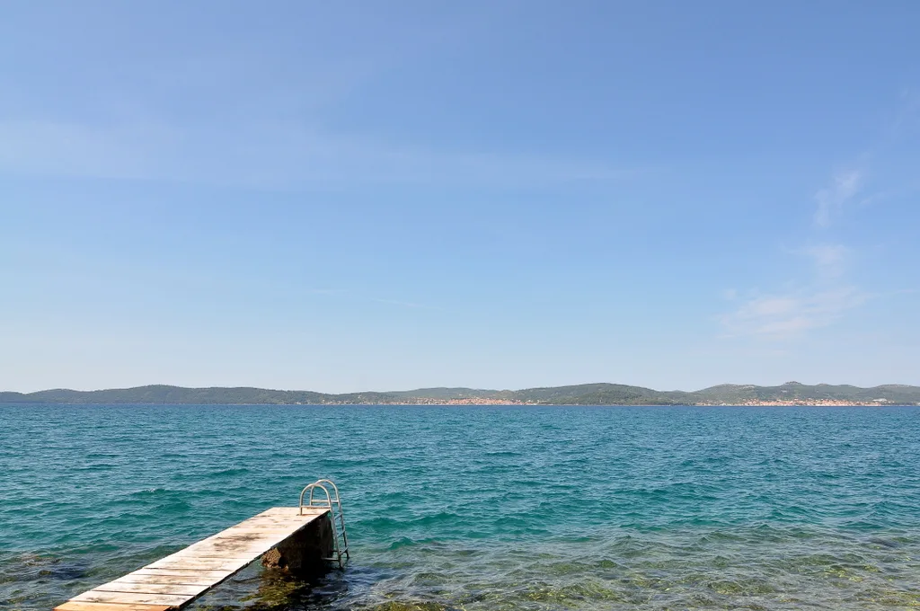 A small jetty and calm open sea on the coast at Zadar