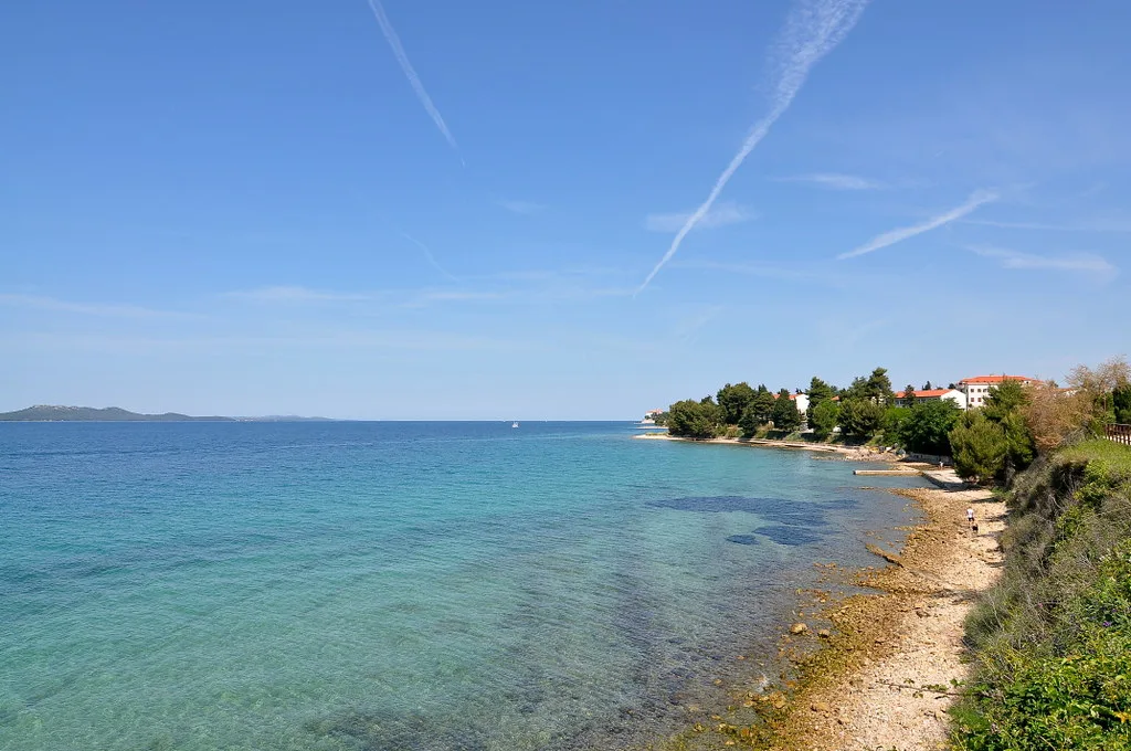 Clear shallow water along a pebbly shoreline near Zadar