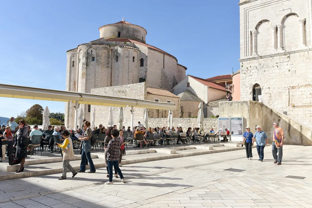Visitors crossing the square beside the round Church of St Donatus in Zadar