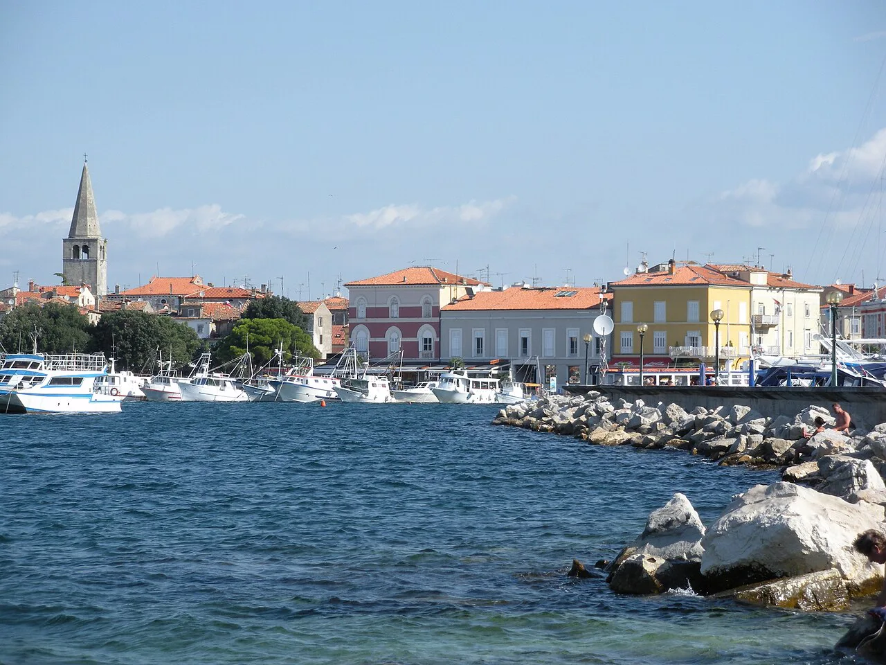 The Poreč old town waterfront with its bell towers seen across the harbour